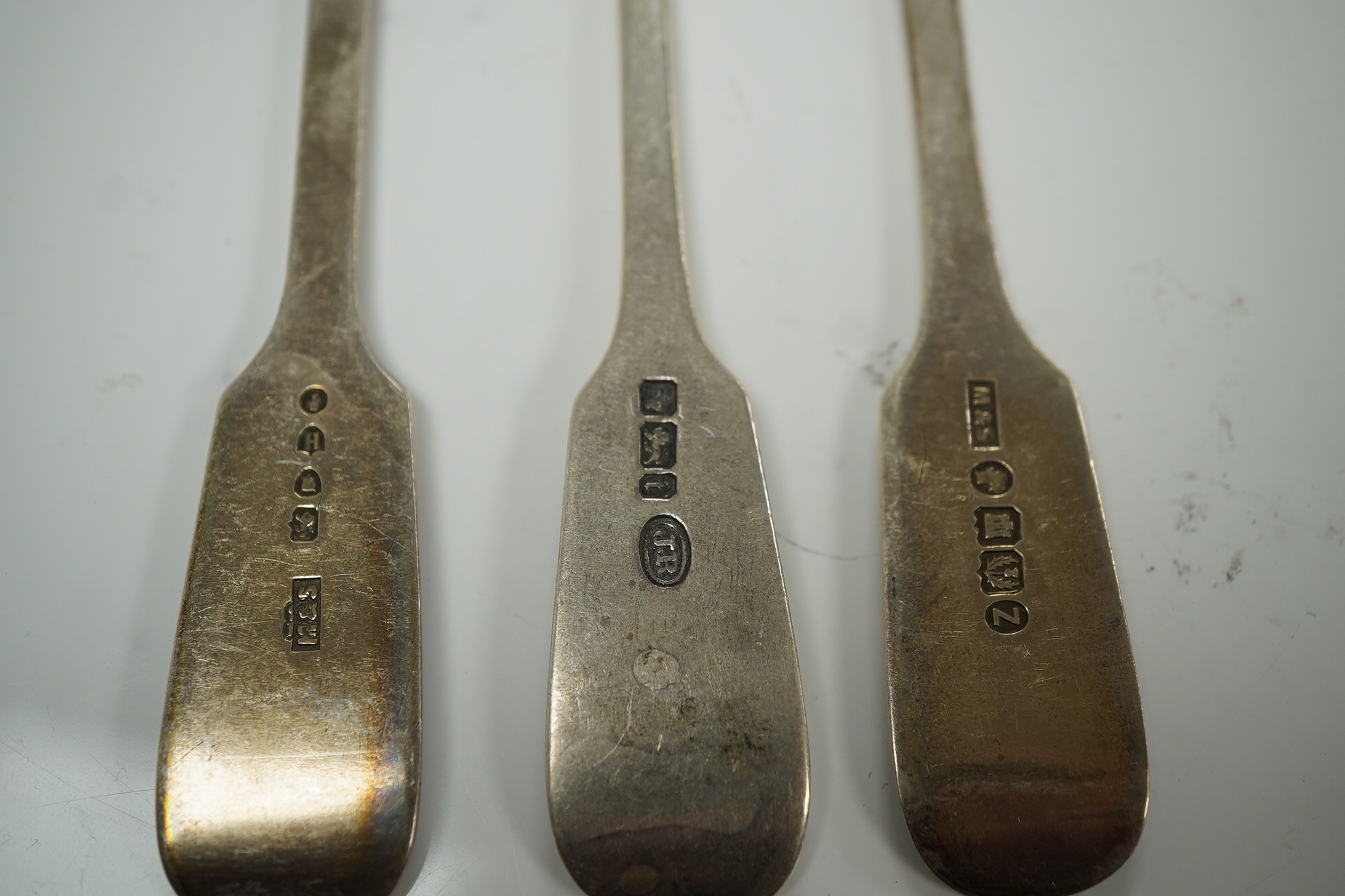 A harlequin set of eight Victorian and later silver fiddle pattern table spoons, various dates and makers. 10.8oz. Condition - fair